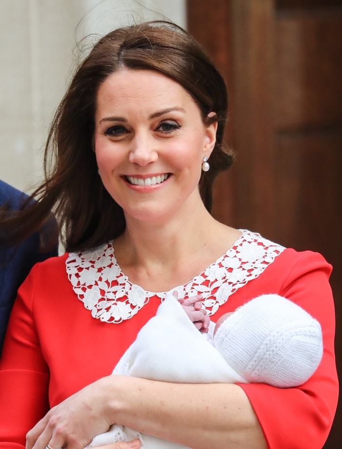 Catherine, Duchess of Cambridge (aka Kate Middleton) in a custom red dress by Jenny Packham featuring a white collar