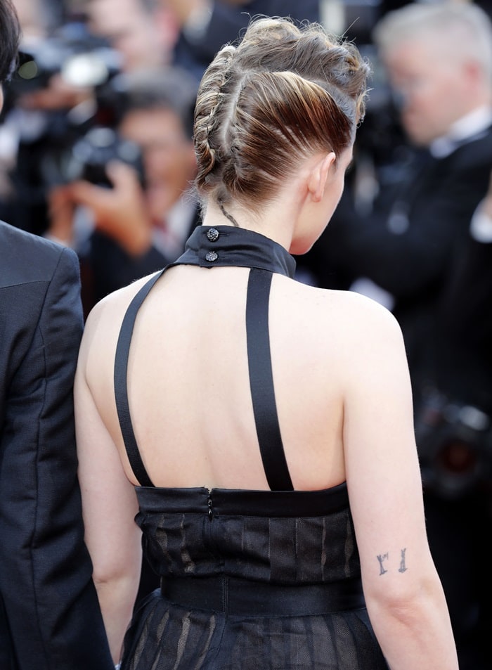 Kristen Stewart stuns with her edgy braided updo and a halter-back black dress at the 2018 Cannes Film Festival