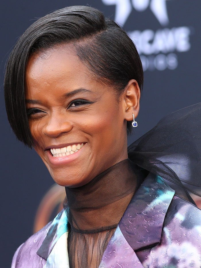 Letitia Wright wearing Norman Silverman Sapphire Earrings and an edgy, blunt short haircut.