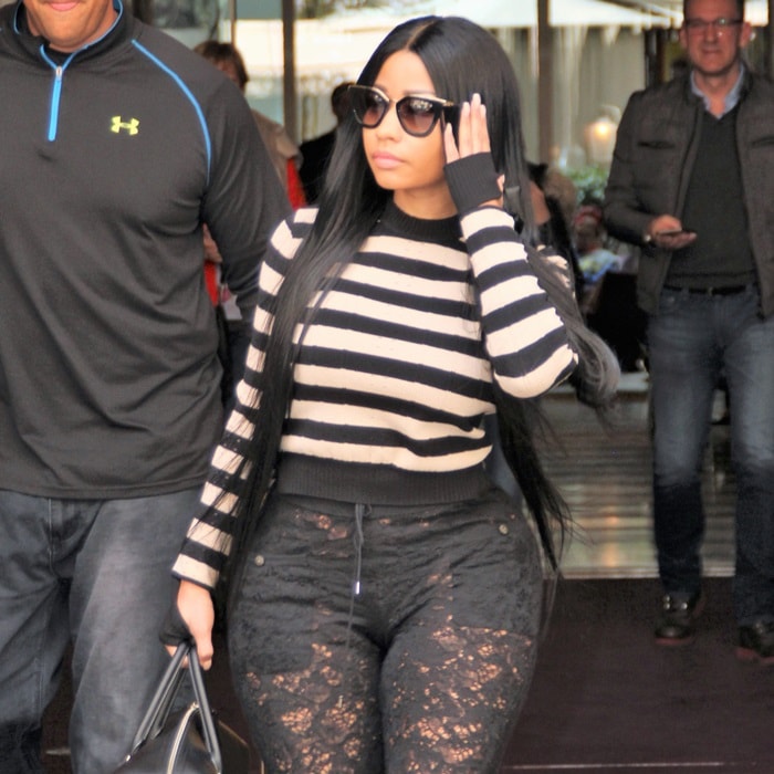 Nicki Minaj showed off her fabulous figure in revealing lace pants paired with a black and white striped sweater