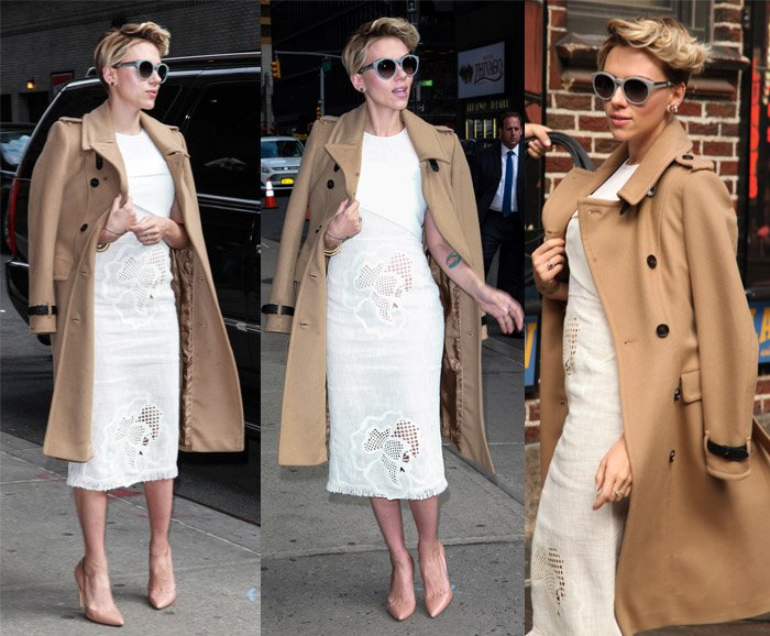 Scarlett Johansson exudes classic elegance in a camel trench coat over a white lace dress, paired with nude pumps for a timeless, sophisticated look
