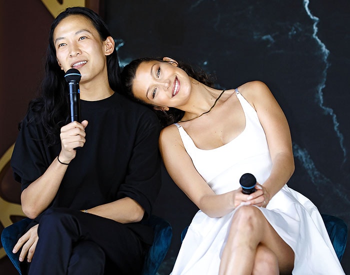 Bella Hadid putting her head on Alexander Wang's shoulder.