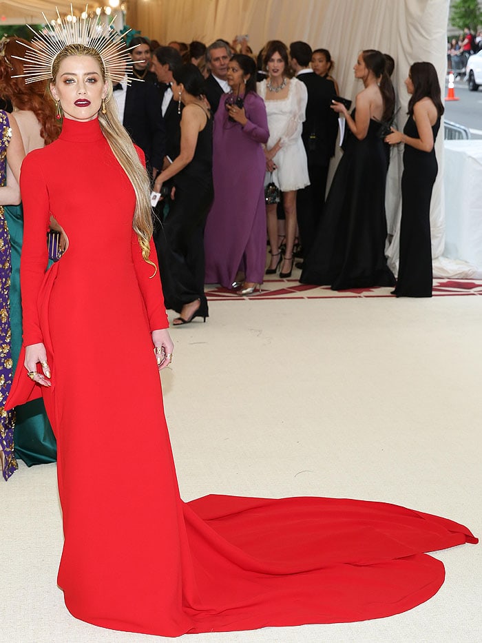 Amber Heard in a Carolina Herrera red long-sleeved gown and an Apatico zip-tie halo.