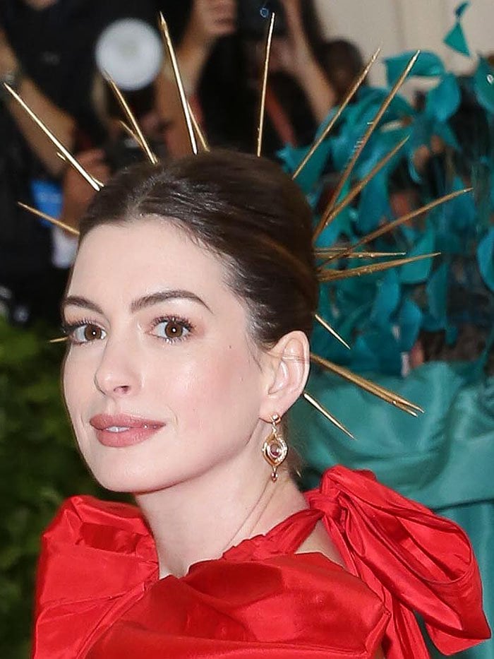Anne Hathaway wearing a gold spiked halo at the 2018 Met Gala.