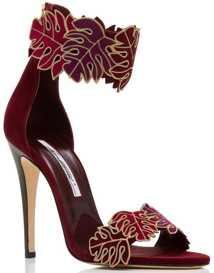 This sandal is rendered in kid suede and features an applique embellishment and stiletto heel
