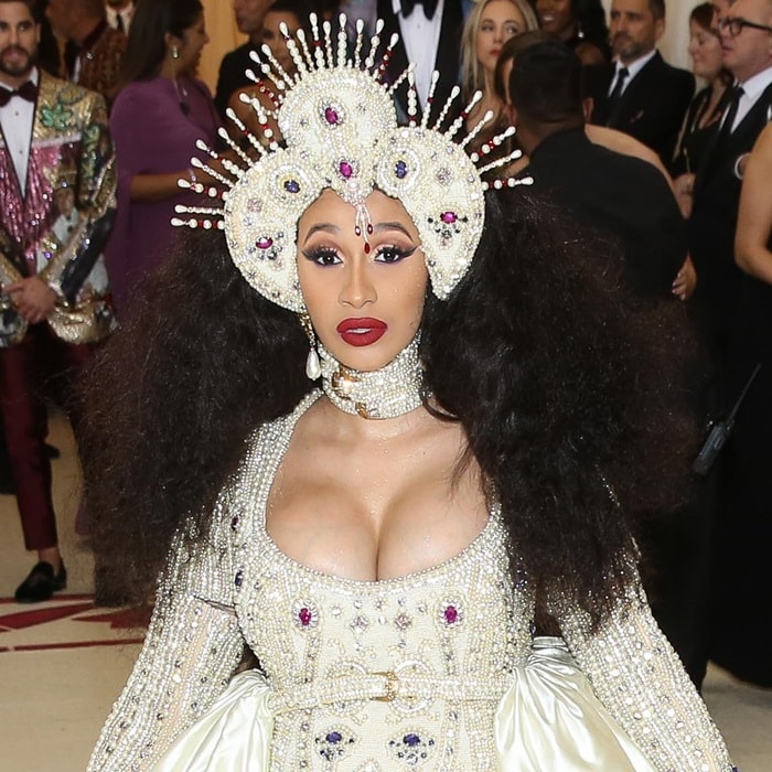 Cardi B's headpiece is covered in pearls, rhinestones, and jewels