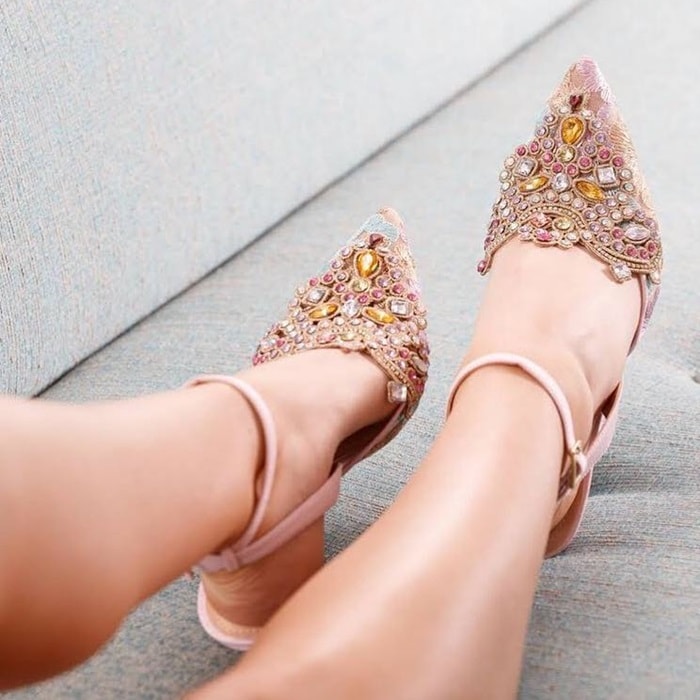 Elegant embroidery and sparkling crystals embellish the pointy toe of a gorgeous, sparkling pump secured by a slim strap that wraps around the ankle