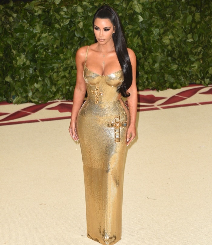 Kim Kardashian in a crucifix-embellished skin-tight Atelier Versace chainmail floor length gown