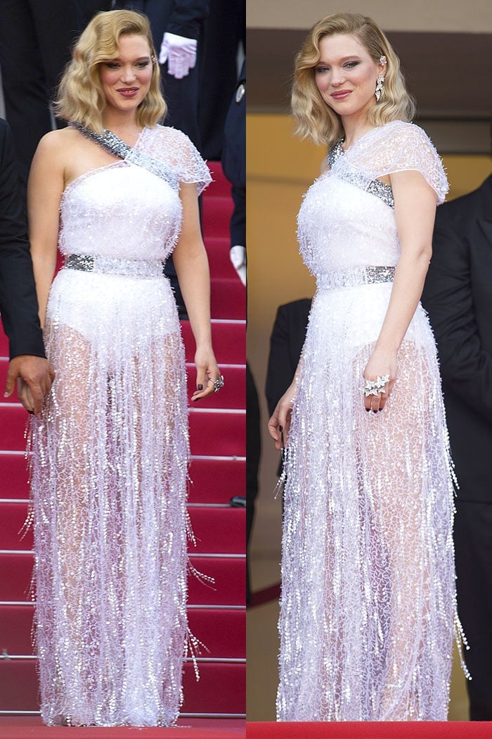 Léa Seydoux dazzles in a custom sheer Louis Vuitton gown adorned with shimmering embellishments and a silver belt, exuding elegance and glamour at Cannes 2018