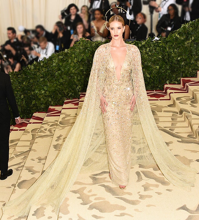 Rosie Huntington-Whiteley in a Ralph Lauren Collection gown and gold Jimmy Choo sandals.