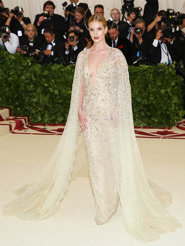 Rosie Huntington Whiteley wearing Ralph Lauren Collection gold embellished gown and gold Jimmy Choo 'Kaylee' sandals at the 2018 Met Gala.