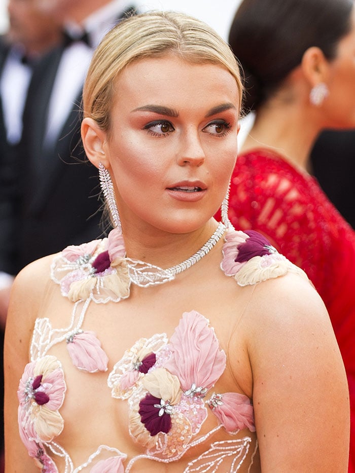 Tallia Storm in a floral embroidered gown with a sheer bodice.