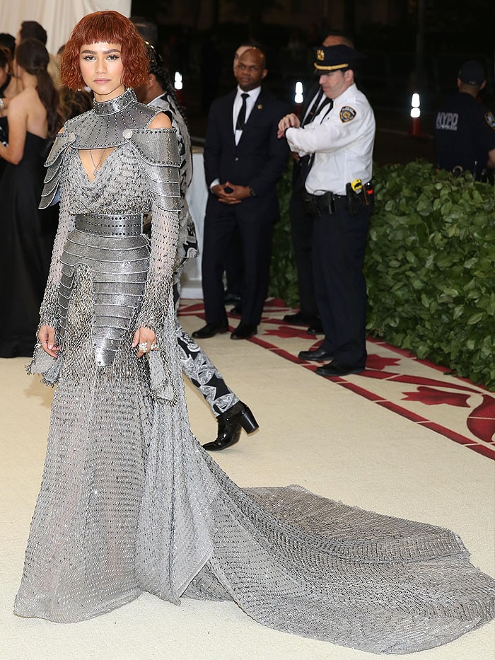 Wearing a custom Versace gown, Zendaya's look featured an armored neck-and-shoulder piece, sparkling chainmail, a spiked belt, and a subtle train