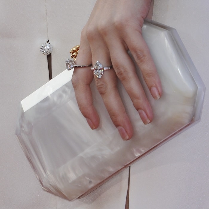 Anna Kendrick showing off her rings and small 'Perry' clutch from Tyler Ellis