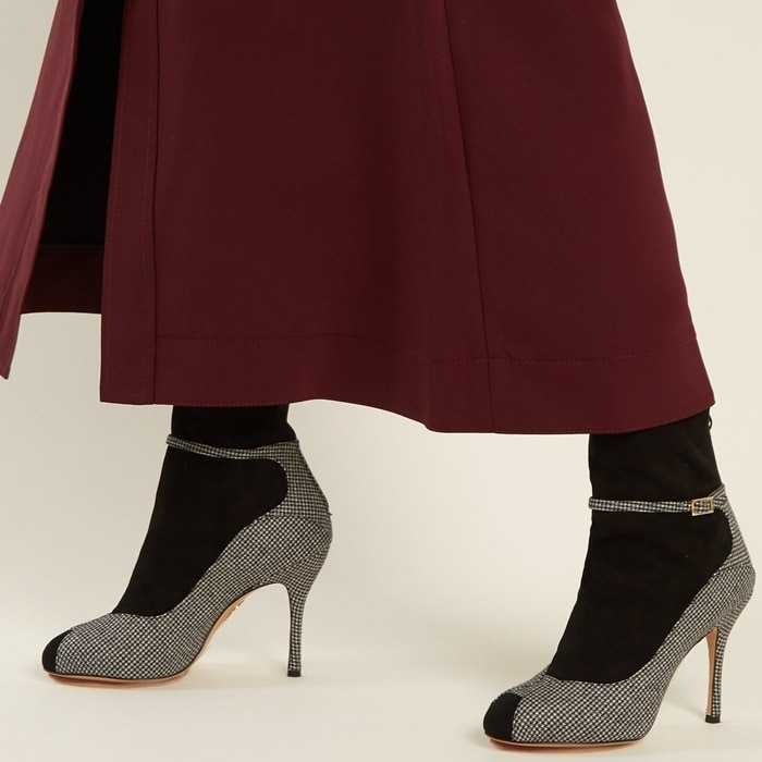 Charlotte Olympia's Incognito boots are aptly named for the black suede sock-like panels that splice the black and white hound's-tooth wool sides, stiletto heel, and buckle-fastening strap