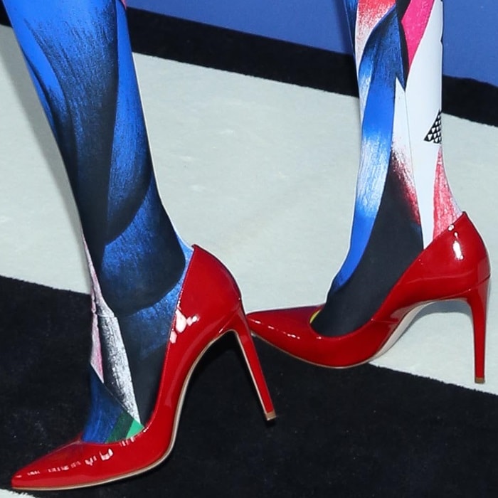 Gigi Hadid rocking flame patent Curvia pointy-toe pumps by Stuart Weitzman