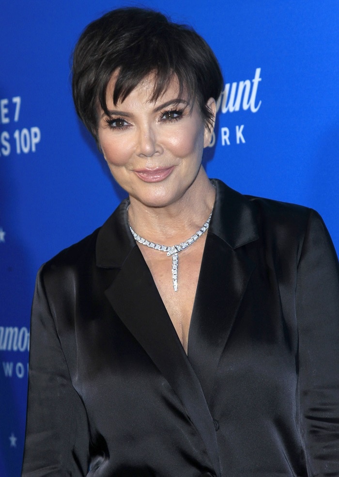 Kris Jenner wearing a sparkling diamond necklace and a black silk blazer mini-dress