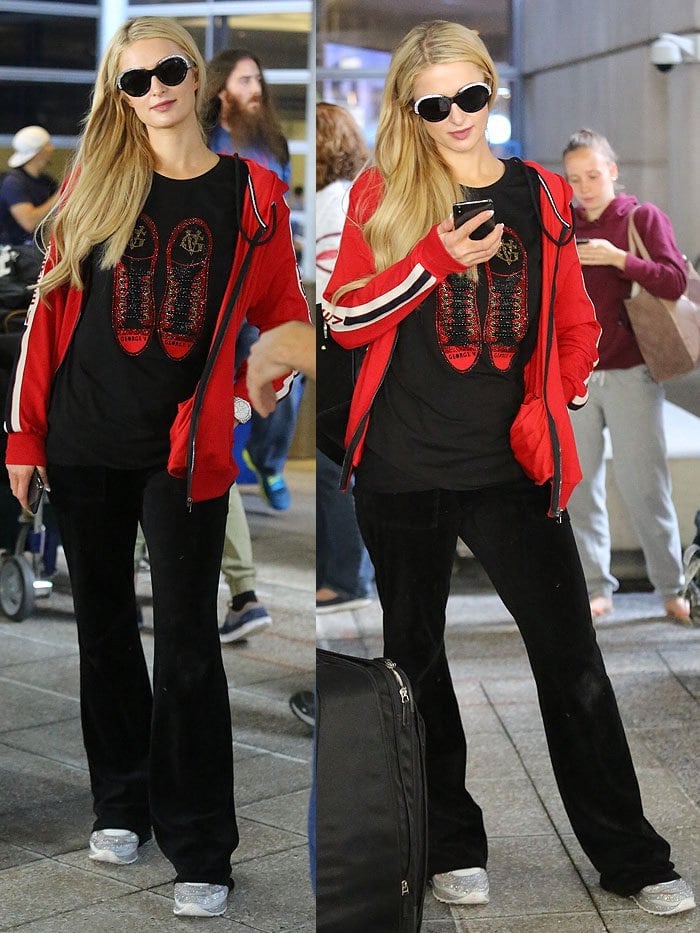 Paris Hilton wearing an Avenue George V homme track jacket and strass-sneaker t-shirt with black velour track pants and Philipp Plein crystal sneakers.