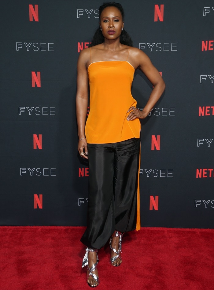 Sydelle Noel wearing black Rachael Cassar harem pants at the GLOW Emmy for Your Consideration event held at the Netflix FYSee at Raleigh Studios in Los Angeles on May 30, 2018