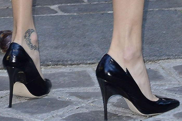 Adriana Lima's hot feet in Redemption eel-skin pumps with spike-notched sides and curved stiletto heels