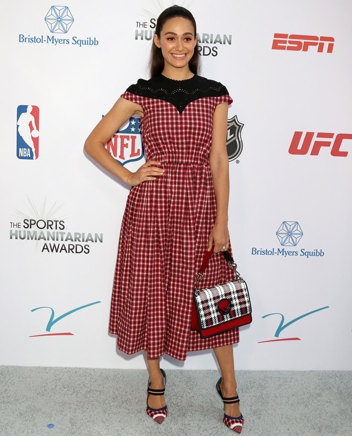 Emmy Rossum stuns in a red and black gingham dress, perfectly coordinated with matching plaid heels and a checkered handbag at the Sports Humanitarian Awards