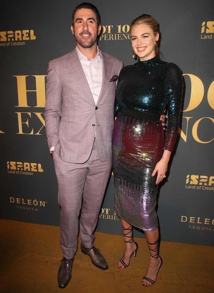 Kate Upton glowed in a sequined Temperley London midi dress and strappy black Jimmy Choo sandals, while Justin Verlander looked sharp in a mauve plaid suit with brown dress shoes at the Hot 100 Experience