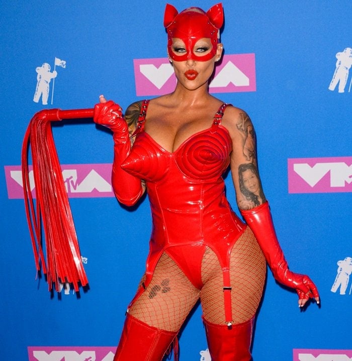 Amber Rose in a bright red leather outfit while hitting the carpet at the 2018 MTV Video Music Awards held at Radio City Music Hall in New York City on August 20, 2018