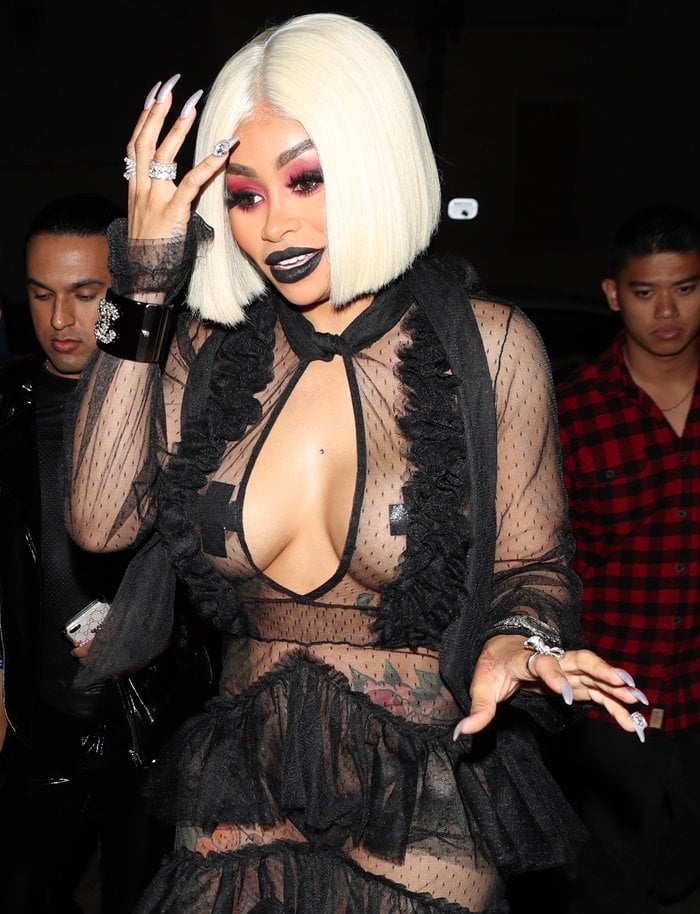 Blac Chyna flashes her nipple covers in an all-black racy ruffled gown