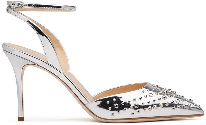 The mirrored silver leather is studded across the pointed toes, with low-slung uppers and a heel-fastening strap creating a streamlined silhouette