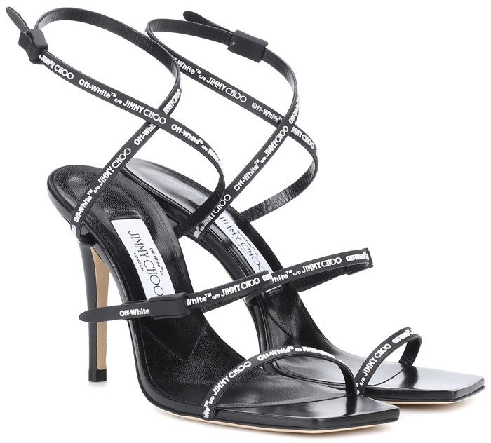 The monochrome design is set on a sleek stiletto heel and comes complete with a squared-toe and dynamic embossed rubber branding adorning the straps