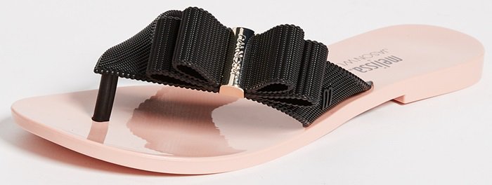 A curvy layered bow sits pertly on the textured strap of a wear-everywhere flip-flop designed in collaboration with Canadian artist and designer Jason Wu.