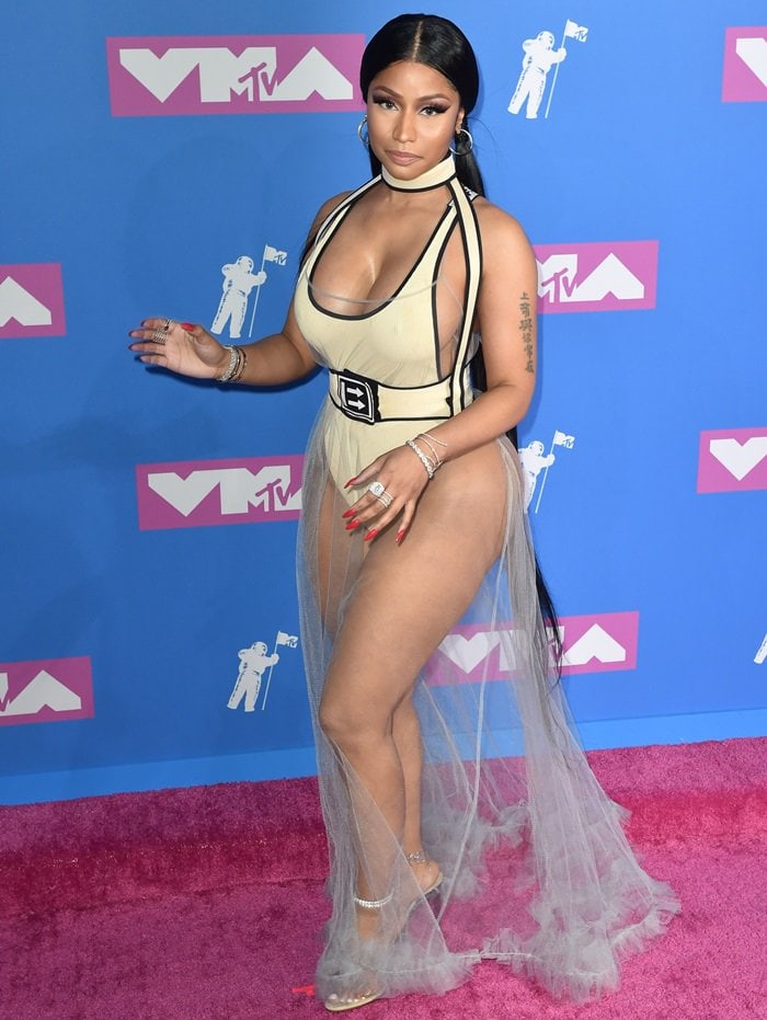 Nicki Minaj in a cream bodysuit with black pipelining from the Off-White c/o Virgil Abloh Fall 2018 RTW Collection