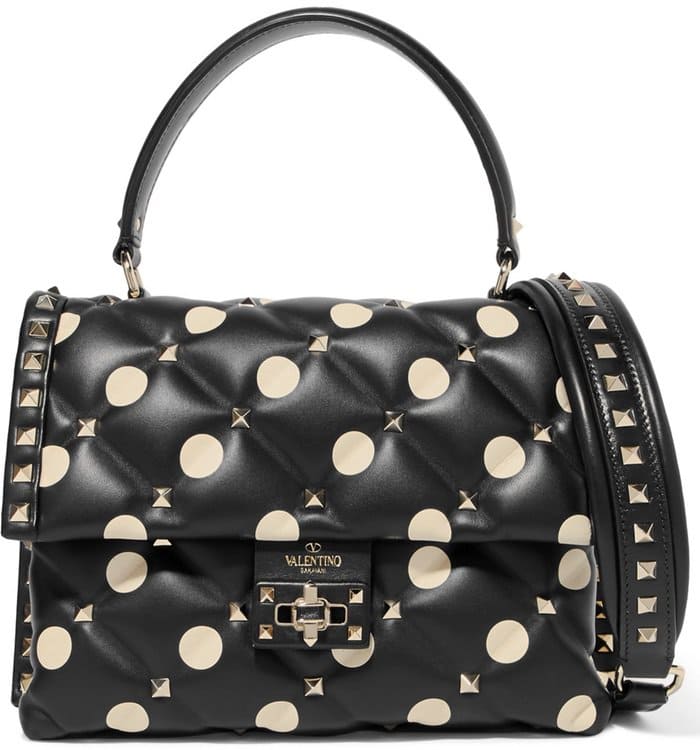 Fusing punk influences with elegant details, this graphic polka-dot version is made from supple black leather stitched with diamond quilting and dotted with the label's signature pyramid studs