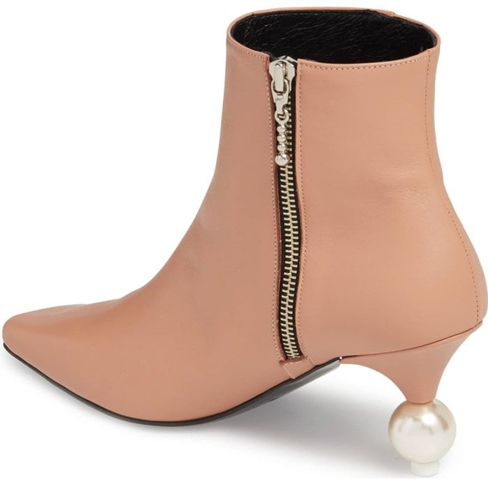 A pearly orb and a curvy cone form the statement heel of a streamlined, minimalist bootie styled with a sharply blunted toe