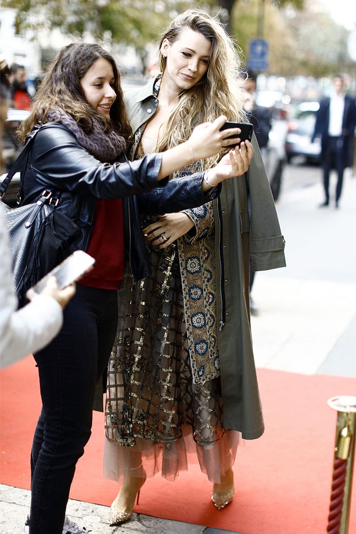 Blake Lively taking a selfie with a fan outside the Christian Dior Spring 2019 fashion show