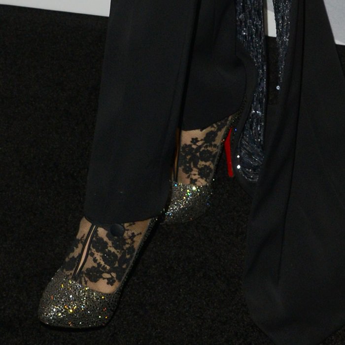 Blake Lively stuns in Christian Louboutin’s Clic Clac lace booties, featuring intricate black lace, glittering accents, and the iconic red sole for a show-stopping finish