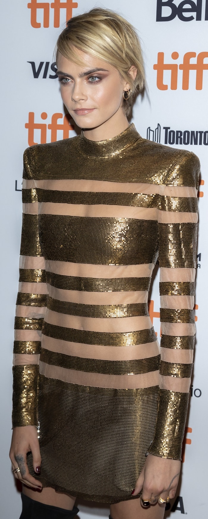 Cara Delevingne in a gold metallic mini dress from the Balmain Fall 2018 Collection