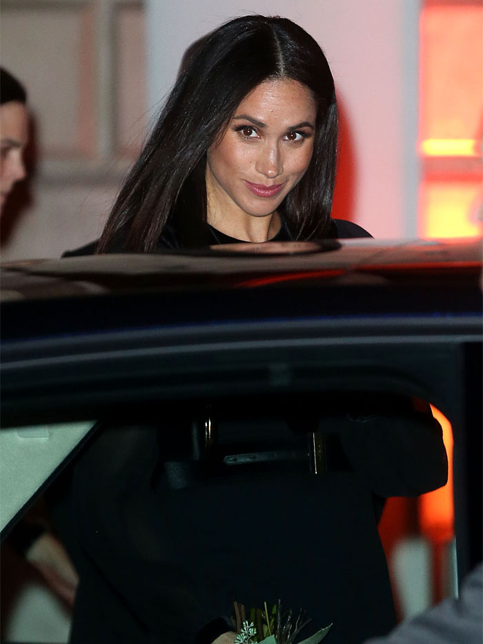 At the 'Oceania' exhibition, Meghan Markle stands out in a captivating Givenchy midi dress, symbolizing her graceful transition into royal duties