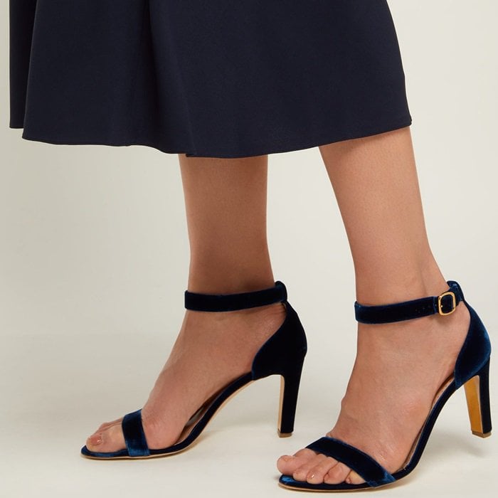 Made in Italy, they sit on a sturdy block heel with a gold interior—one of Rupert Sanderson’s signatures— and feature a thick ankle strap secured with a gold-tone metal buckle