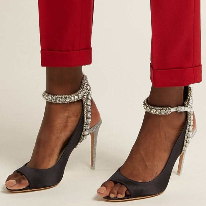 Imbued with glamour, these black satin sandals are set on a silver glitter heel with a crystal-embellished strap that will dazzle with every step