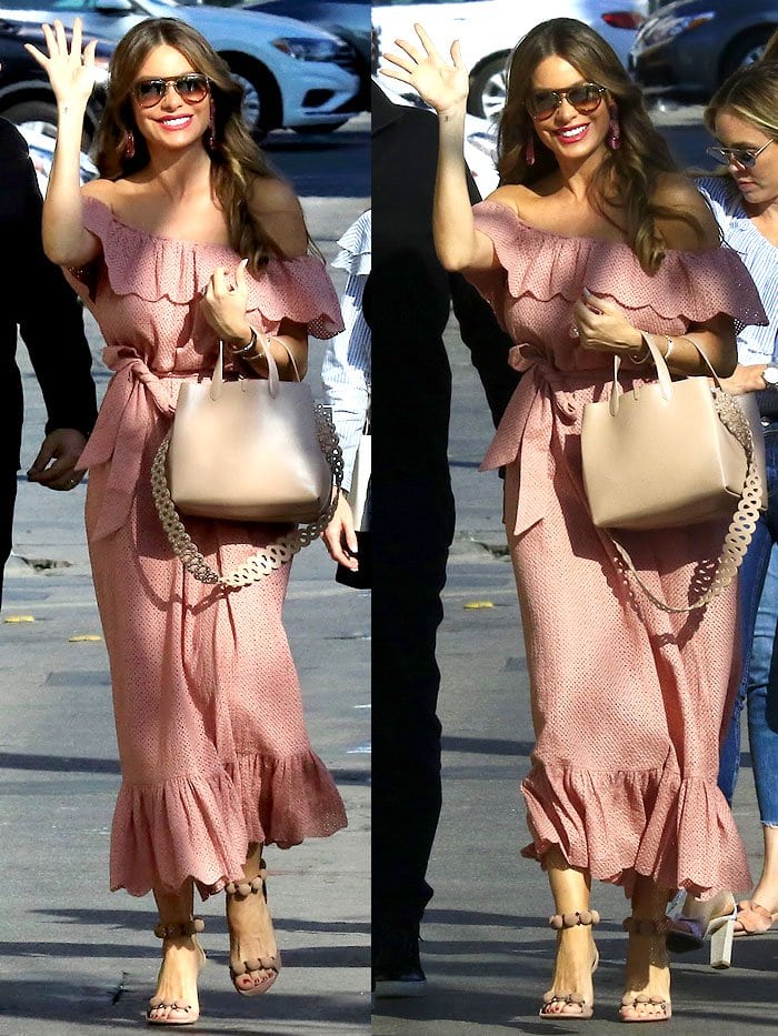 Sofia Vergara in a Lisa Marie Fernandez pink off-shoulder dress, Alaia 'Bombe' sandals, and Alaia studded-strap handbag