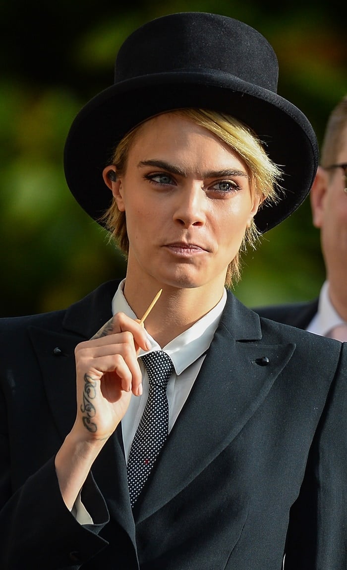 Cara Delevingne did her best to grab attention with a toothpick at the wedding of Princess Eugenie and Jack Brooksbank