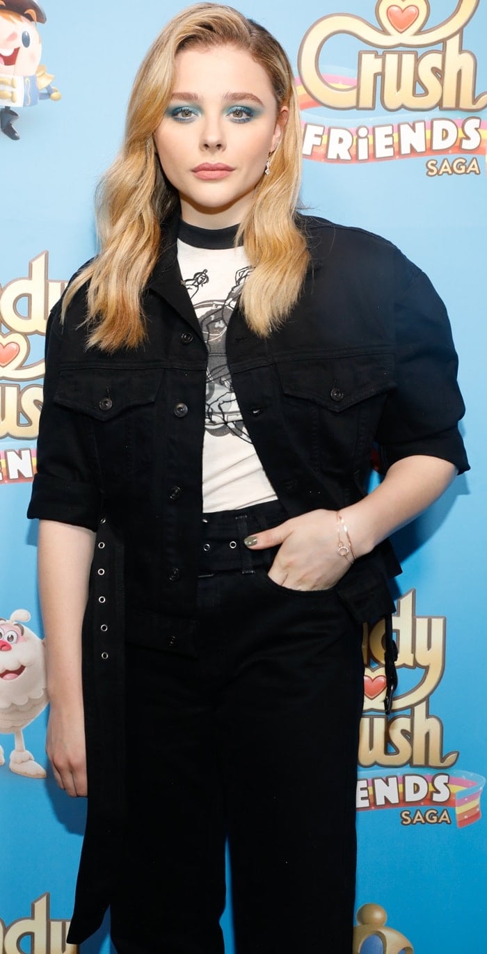 Chloë Grace Moretz wearing black cropped pants to the launch of the new Candy Crush Friends Saga game in New York City on October 11, 2018