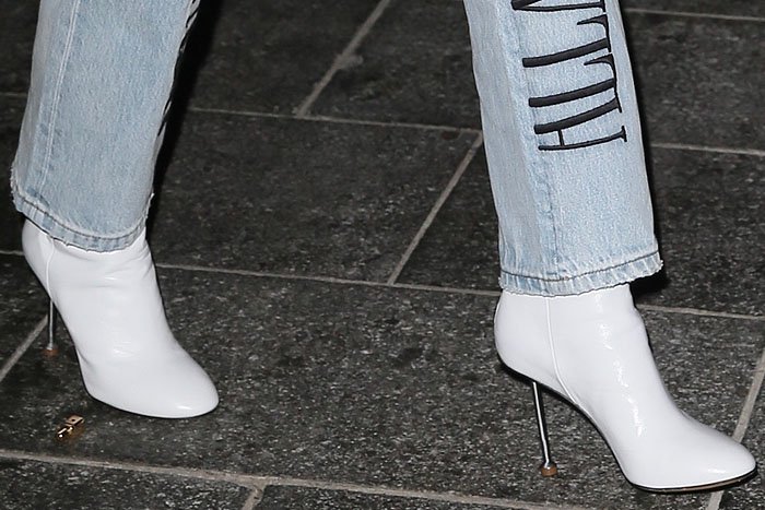 Closeup of Ellie Goulding's Maison Margiela white-leather nail-heel boots