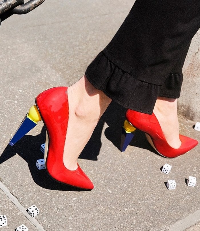 A sculptural statement heel grounds this sleek pump with stunning modern style