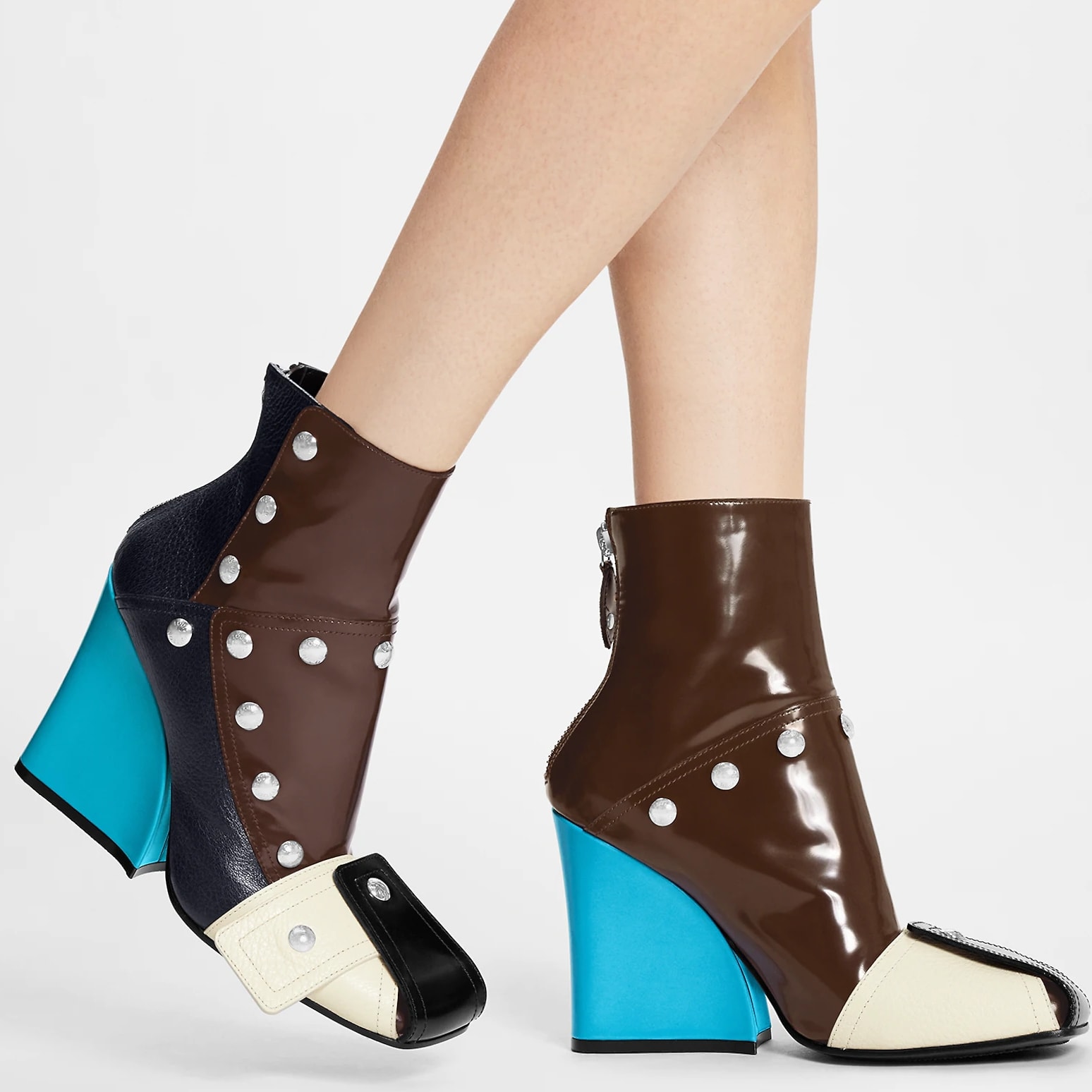 Louis Vuitton's Patti wedge ankle boot combines calf leather with supple, grained goat leather