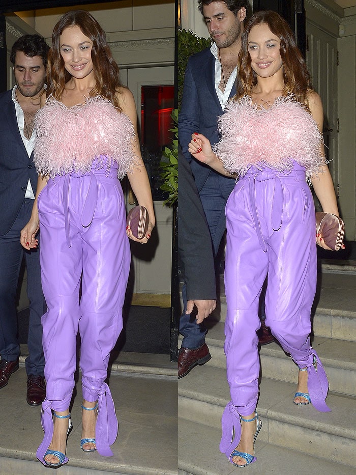 Olga Kurylenko stepping on the long ankle ties of her Attico light-purple leather pants