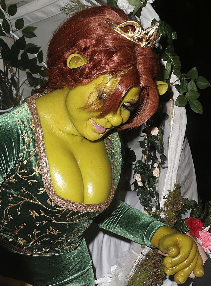 Heidi Klum fully transformed into Princess Fiona from Shrek with detailed green prosthetics and a regal velvet gown
