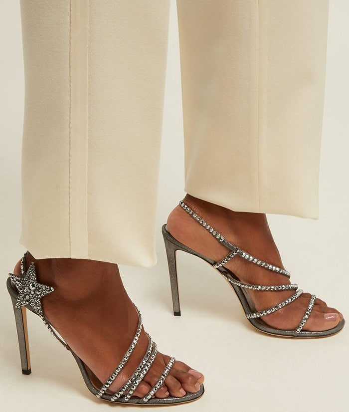 Under the creative direction of Sandra Choi, Jimmy Choo offers the perfect mix of elegant silhouettes and modern, whimsical details, as illustrated by these anthracite shimmer suede Lynn sandals