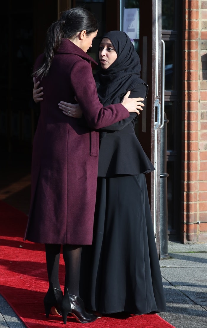 Meghan, Duchess of Sussex wore a burgundy Sallyet by Club Monaco dress with velvet collar detail